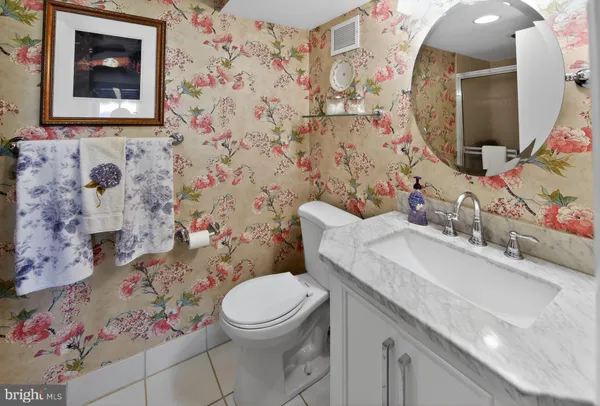 a bathroom with a sink mirror vanity and toilet