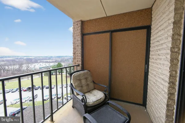 a view of a balcony with chair and wooden floor