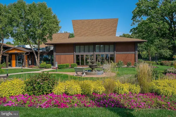 a house view with swimming pool and garden space