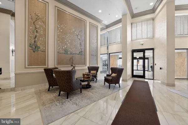 a living room with furniture and large windows