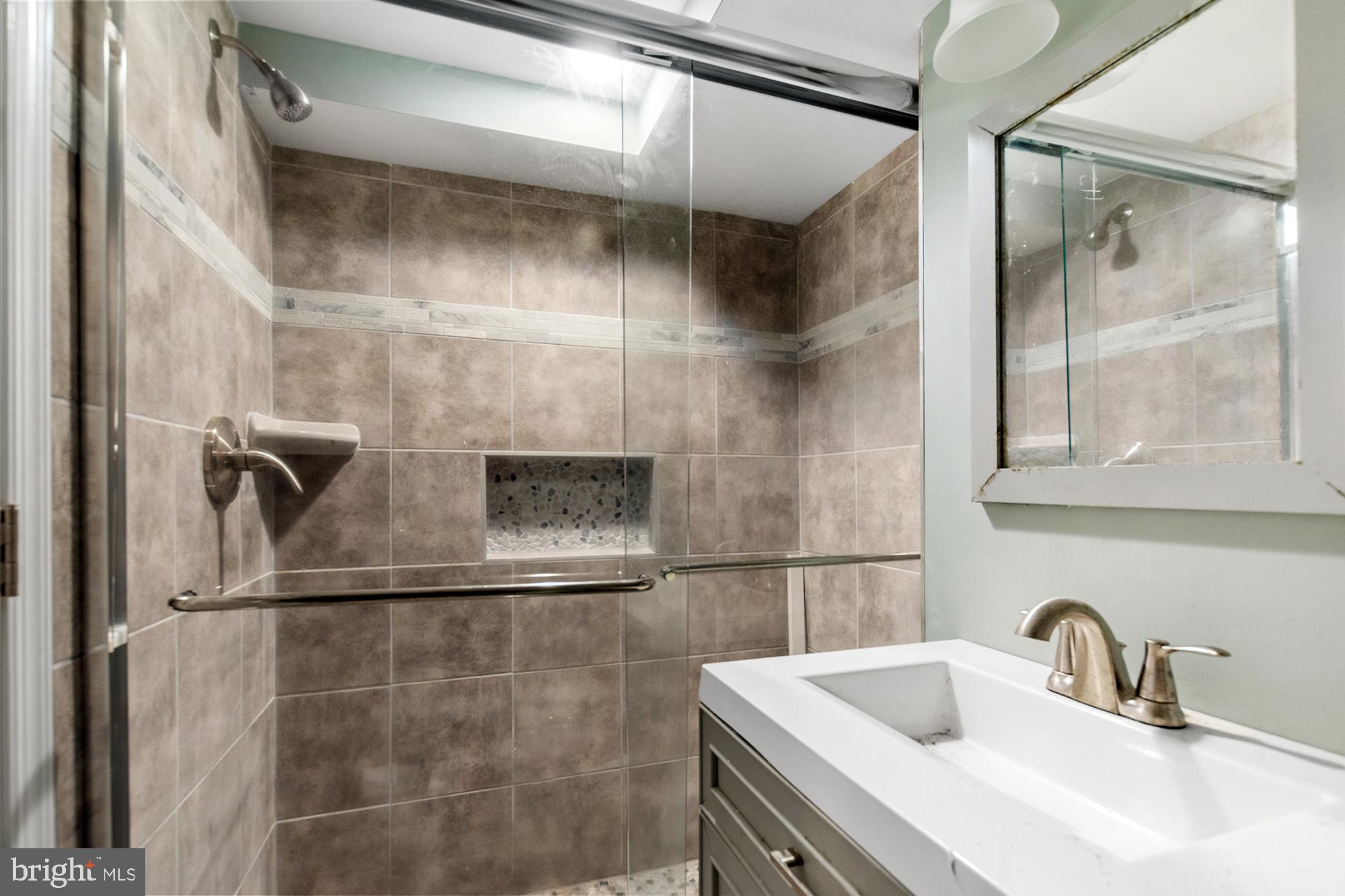 1433 Federal Street Baltimore, MD 21213 - Photo 3 of 9 a bathroom with a sink and mirror