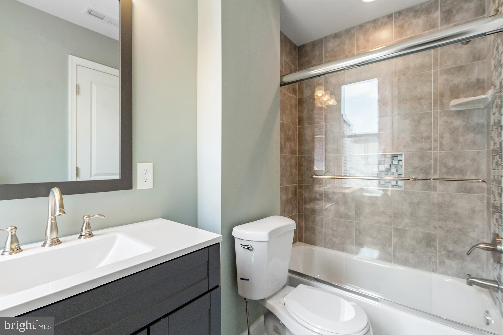1433 Federal Street Baltimore, MD 21213 - Photo 4 of 9 a bathroom with a sink toilet and shower