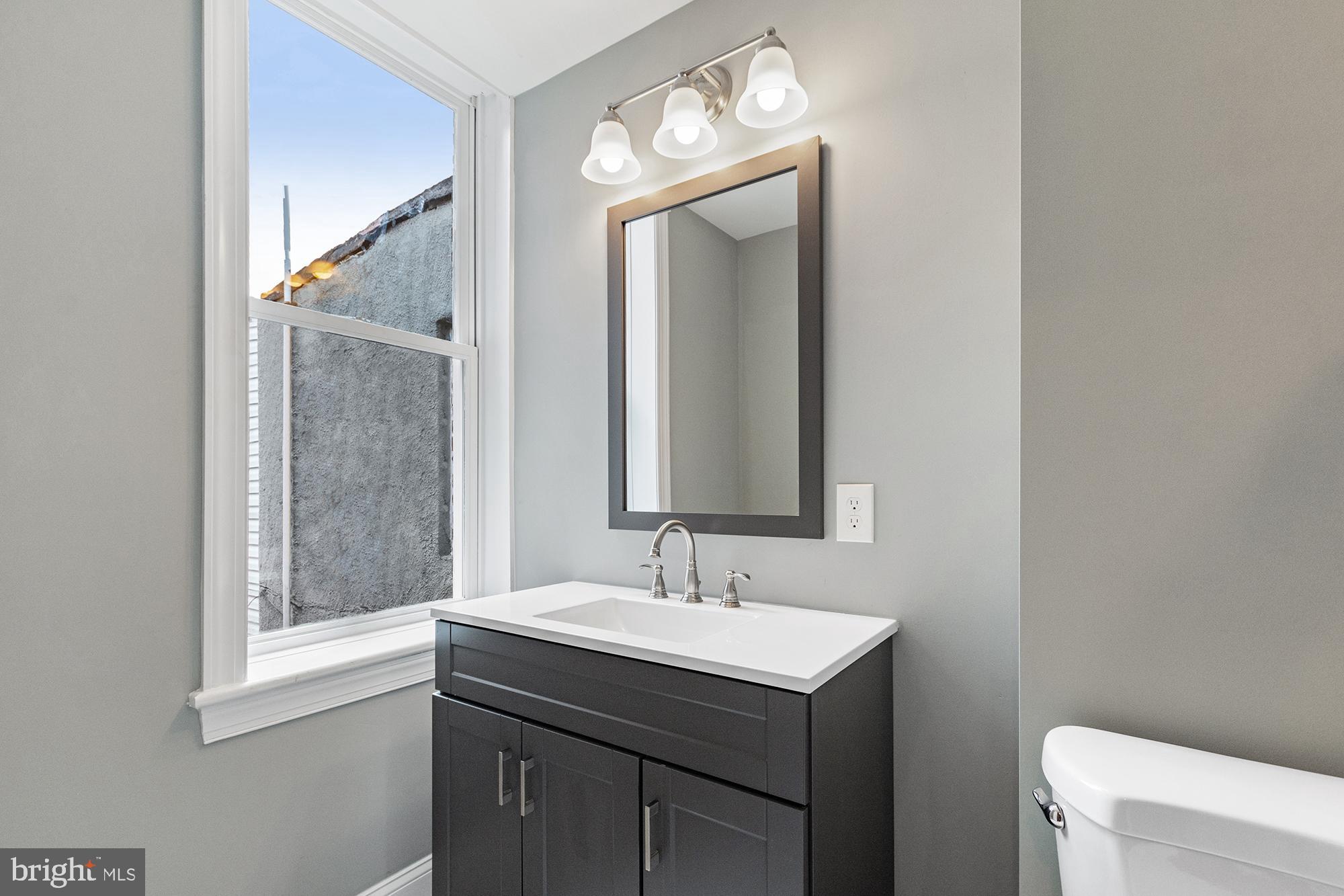 1433 Federal Street Baltimore, MD 21213 - Photo 6 of 9 a bathroom with a sink and a mirror