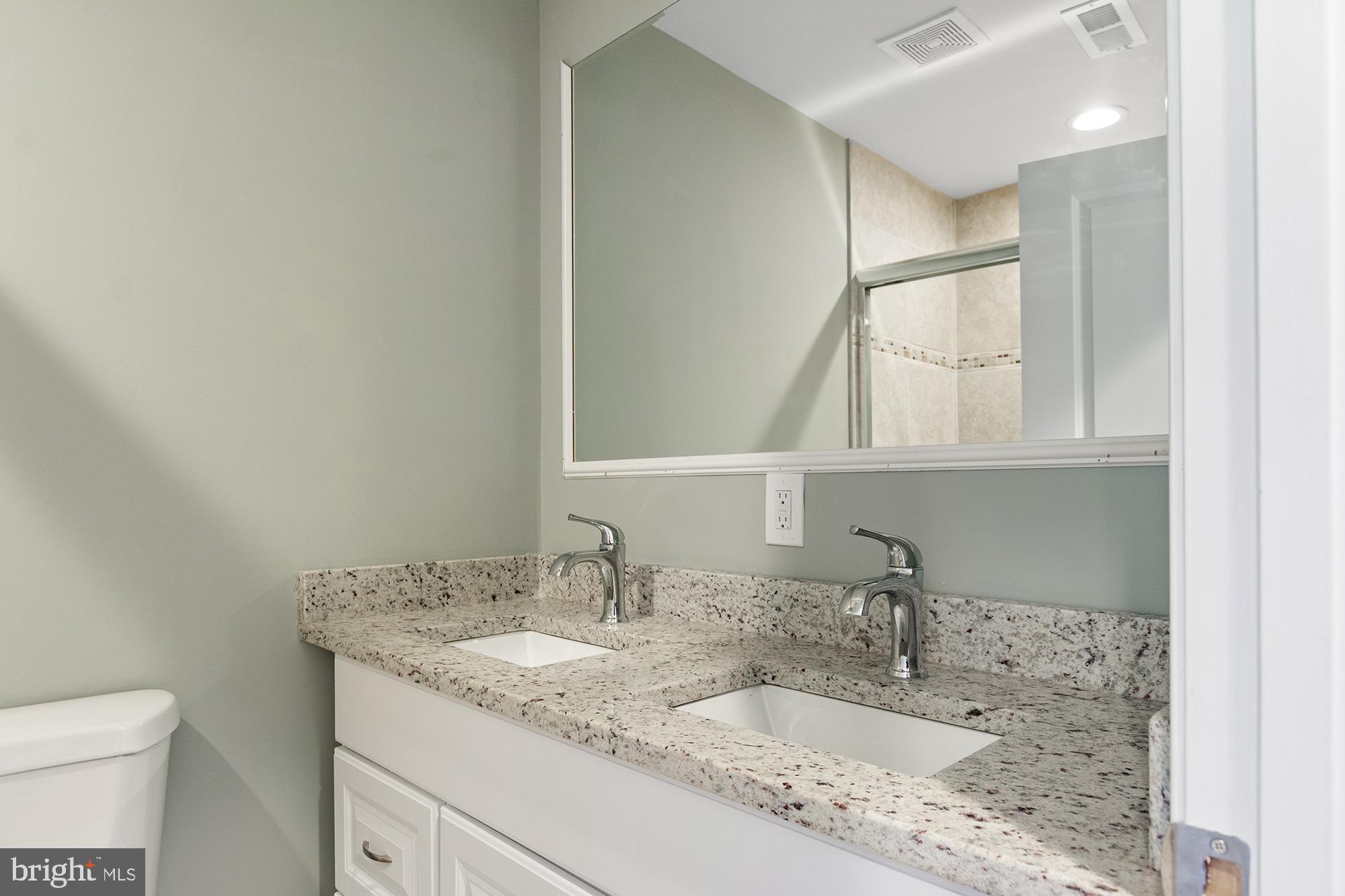 1433 Federal Street Baltimore, MD 21213 - Photo 8 of 9 a bathroom with a granite countertop sink and a mirror