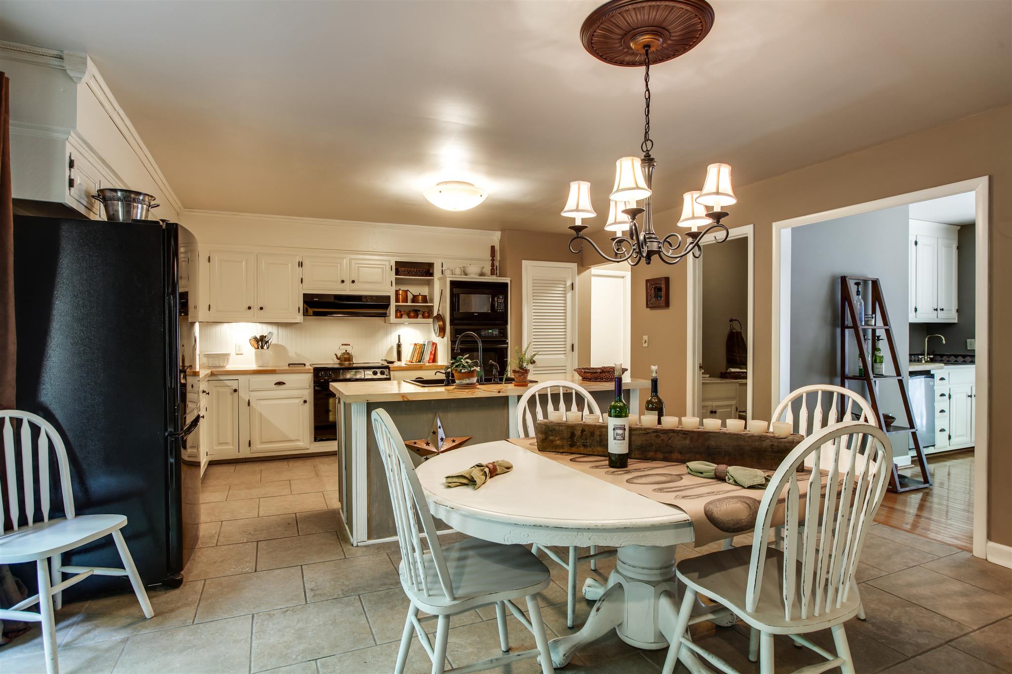 823 High Point Ridge Road Franklin, TN 37069 - Photo 12 of 30 a kitchen with stainless steel appliances granite countertop a dining table chairs and a refrigerator