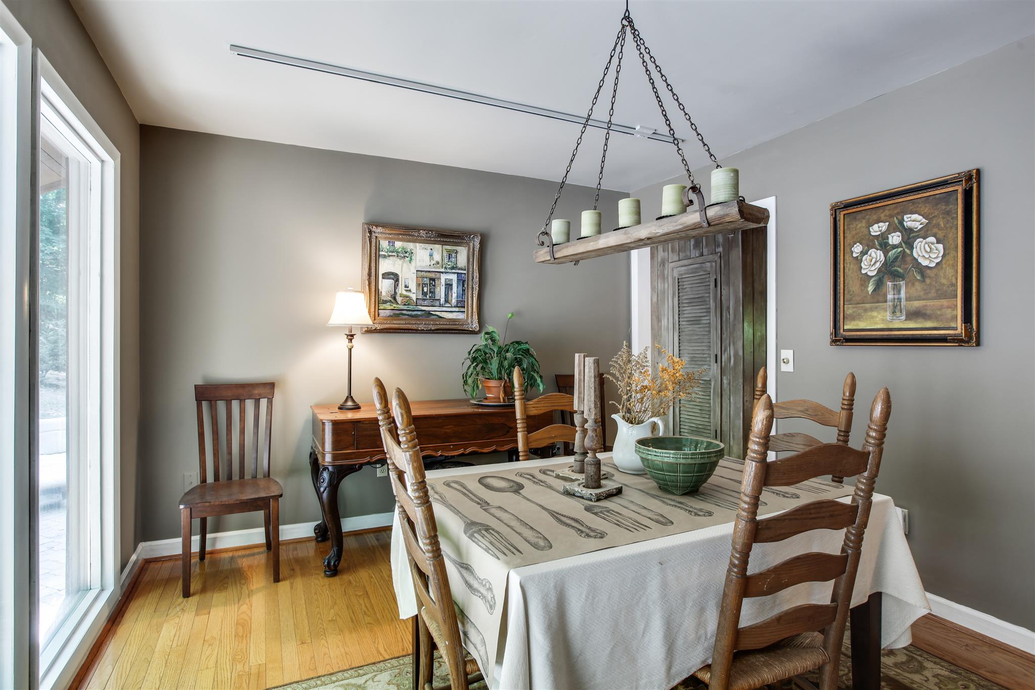 823 High Point Ridge Road Franklin, TN 37069 - Photo 9 of 30 a dining room with wooden floor a chandelier a wooden table and chairs