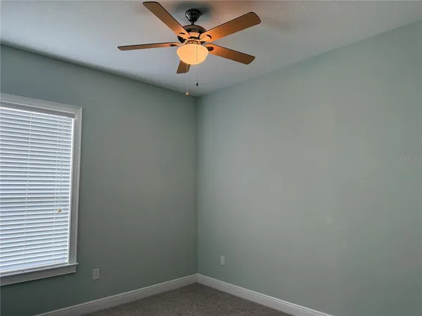 a bathroom with a granite countertop sink and a toilet