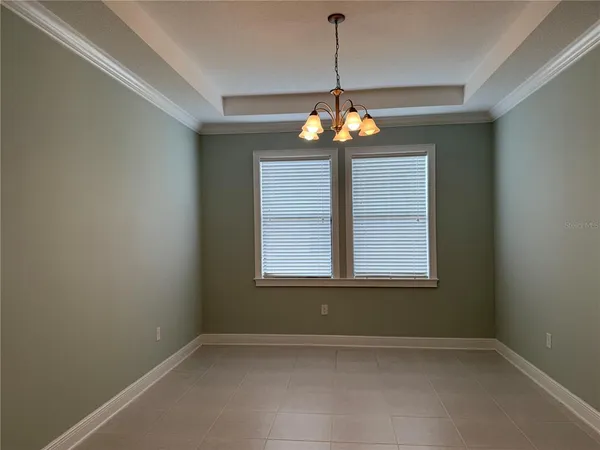 a view of a room with windows and chandelier