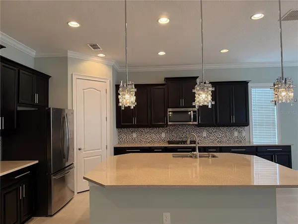 a large kitchen with stainless steel appliances kitchen island a large island in the center