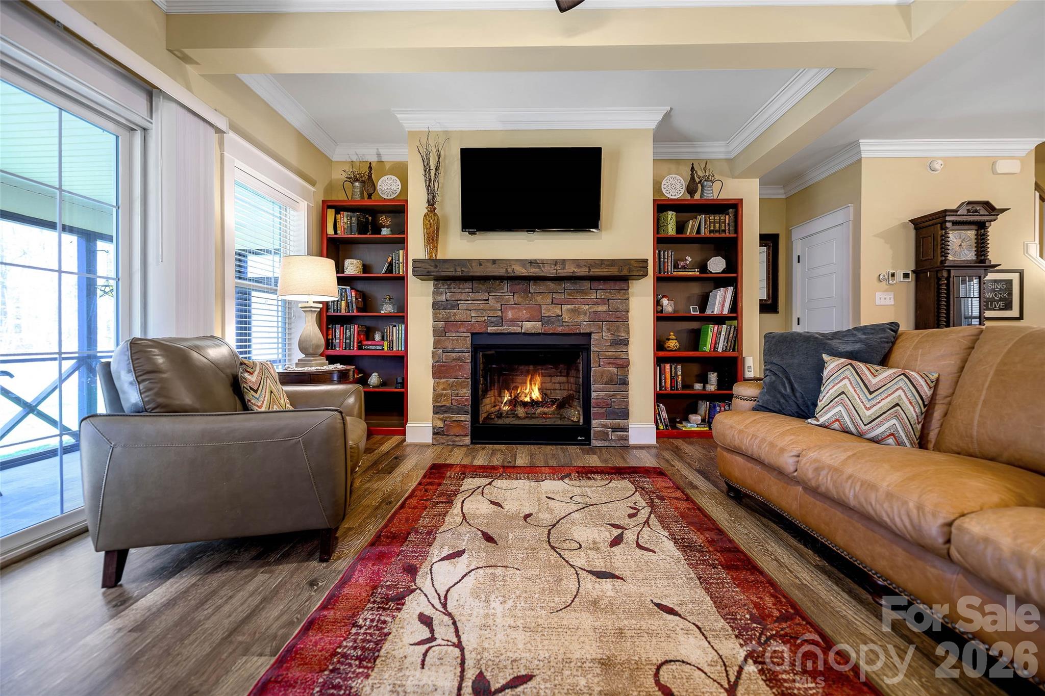 211 Holly Ridge Road Dallas, NC 28034 - Photo 16 of 46 a living room with furniture a flat screen tv and a fireplace