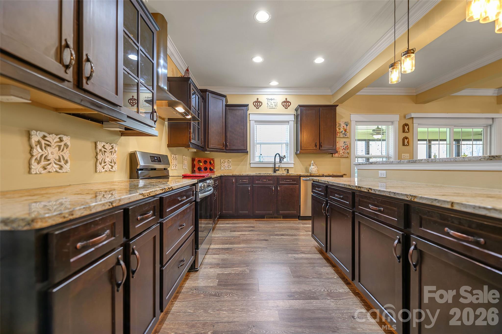 211 Holly Ridge Road Dallas, NC 28034 - Photo 19 of 46 a kitchen with stainless steel appliances granite countertop wooden cabinets a sink and dishwasher a oven with wooden floors