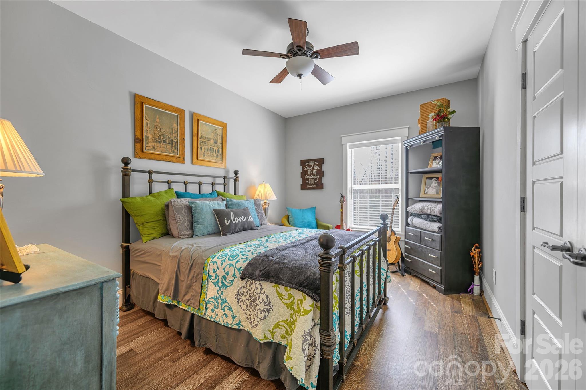 211 Holly Ridge Road Dallas, NC 28034 - Photo 26 of 46 a bedroom with a bed and a chandelier