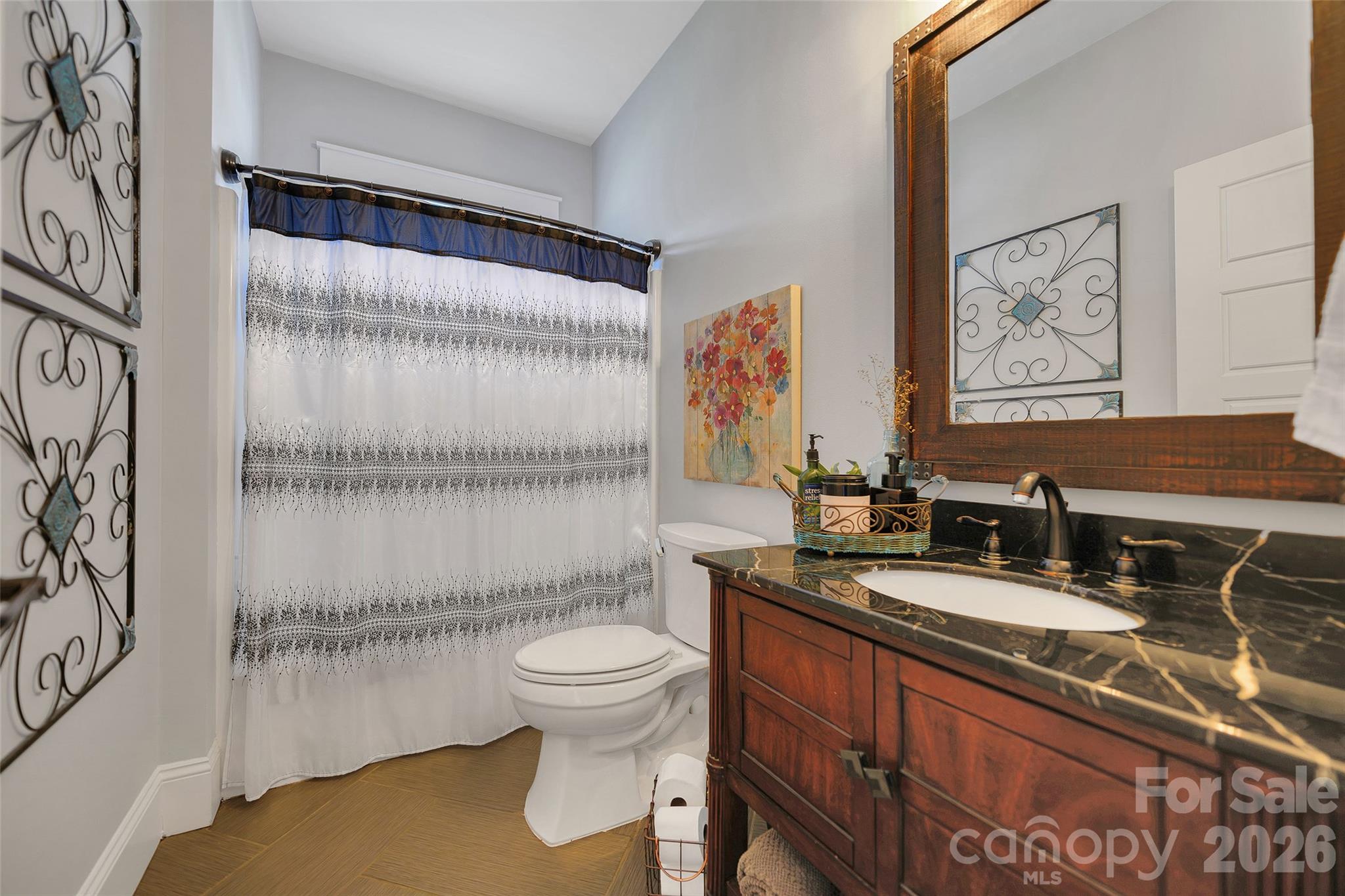 211 Holly Ridge Road Dallas, NC 28034 - Photo 29 of 46 a bathroom with a granite countertop sink mirror vanity and toilet