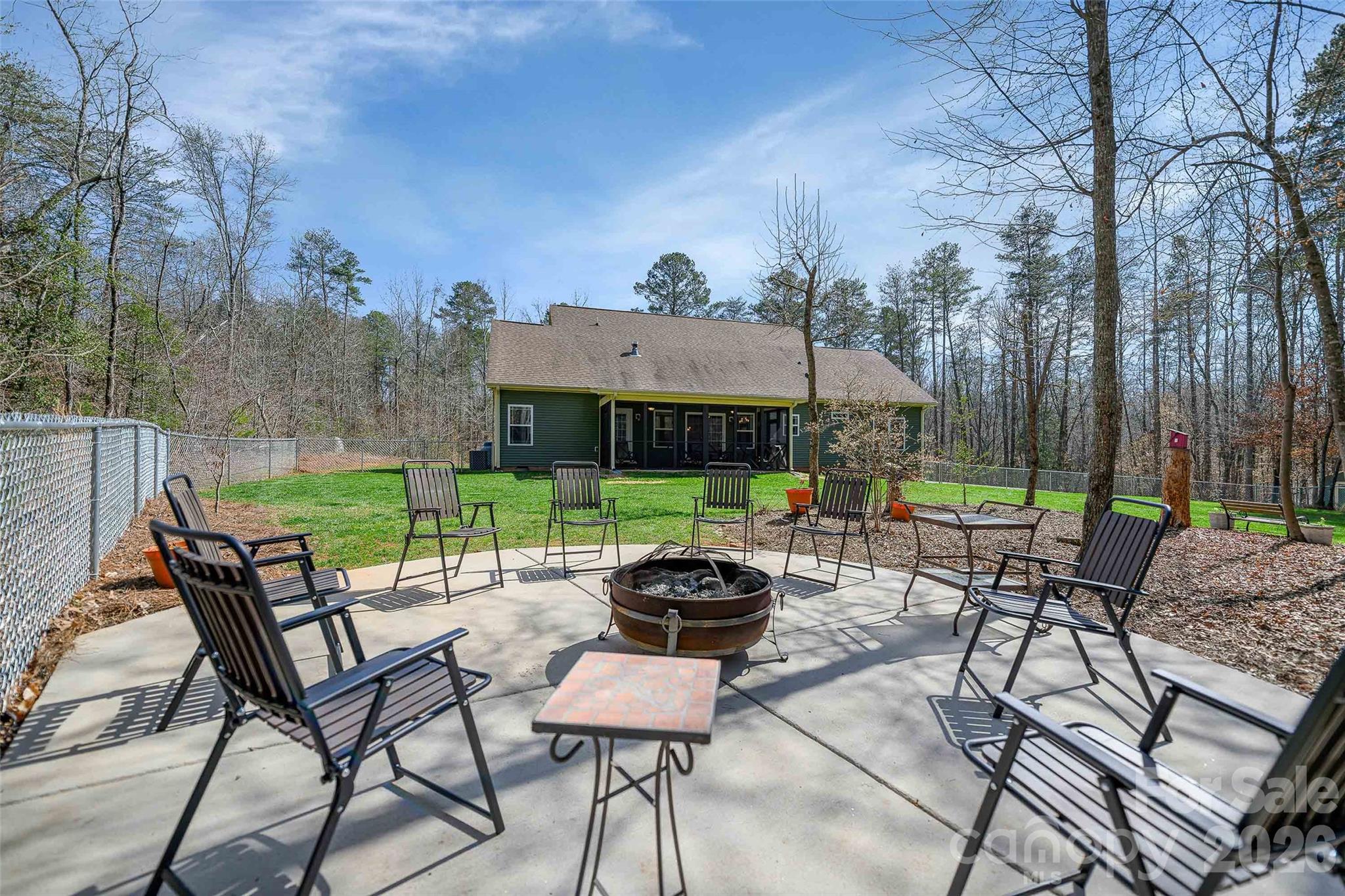 211 Holly Ridge Road Dallas, NC 28034 - Photo 41 of 46 a view of a chairs and table in the back yard