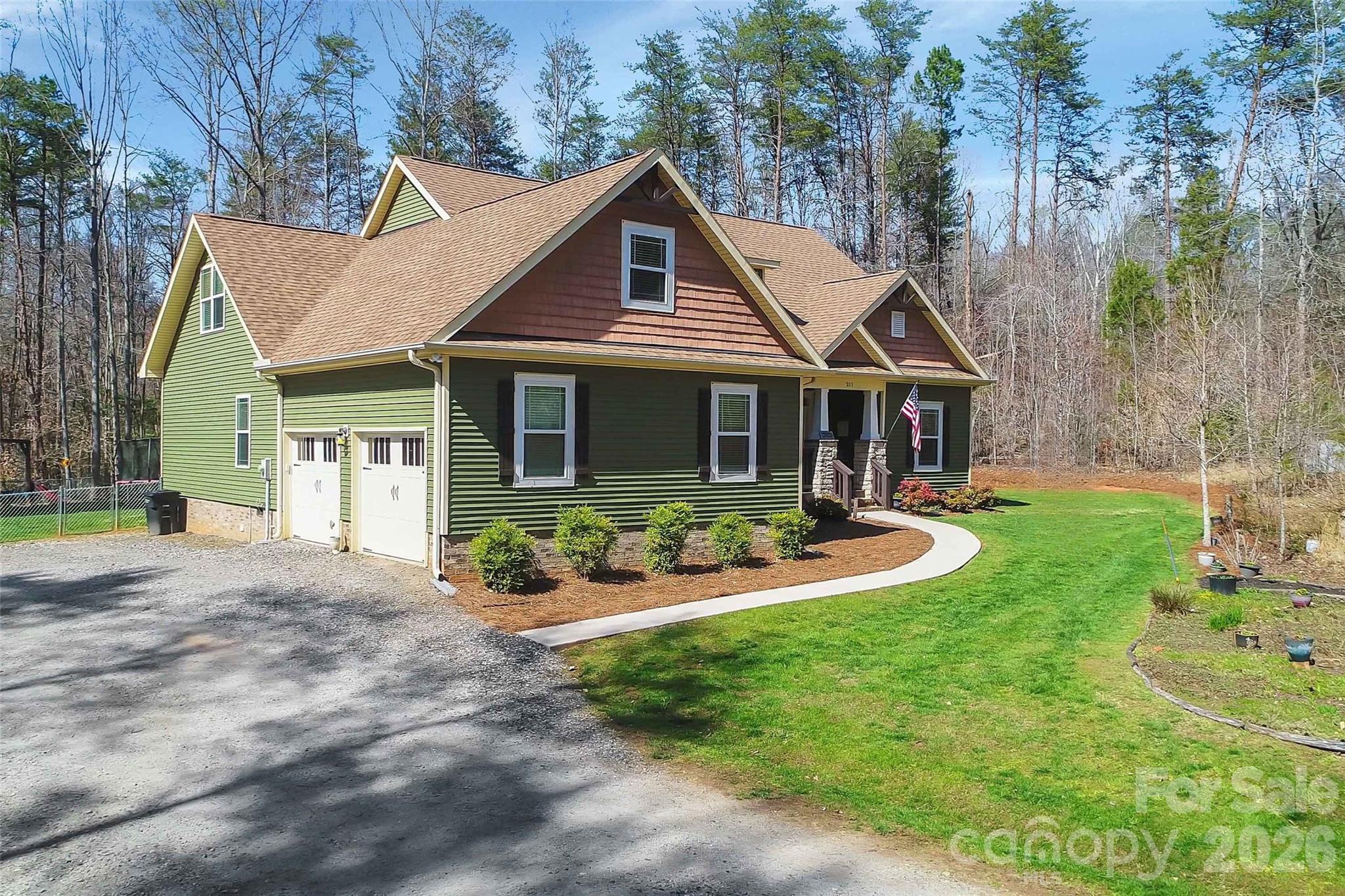 211 Holly Ridge Road Dallas, NC 28034 - Photo 43 of 46 a front view of a house with garden and porch
