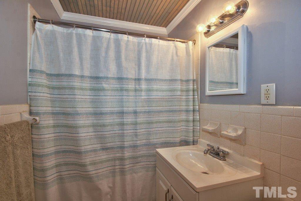 25 Bagwell Avenue Raleigh, NC 27607 - Photo 13 of 19 a bathroom with a sink a vanity and a shower
