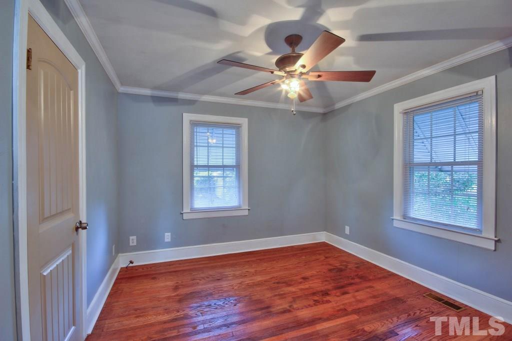 25 Bagwell Avenue Raleigh, NC 27607 - Photo 14 of 19 an empty room with wooden floor fan and windows