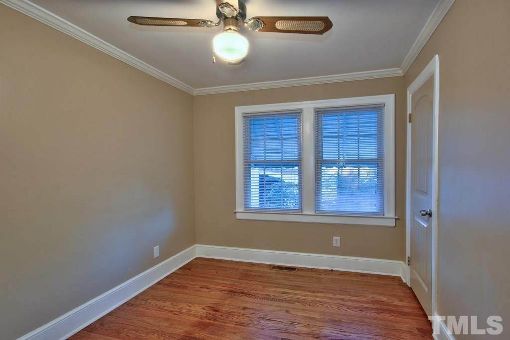 25 Bagwell Avenue Raleigh, NC 27607 - Photo 15 of 19 an empty room with wooden floor fan and windows