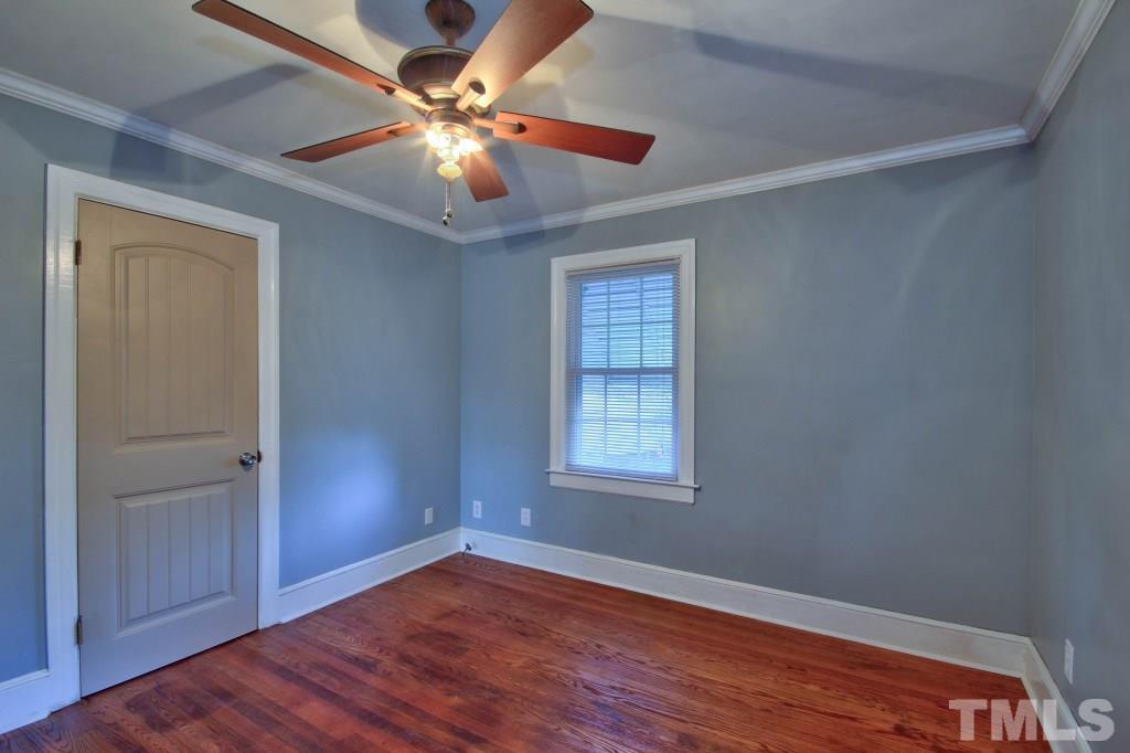 25 Bagwell Avenue Raleigh, NC 27607 - Photo 16 of 19 an empty room with wooden floor chandelier fan and windows
