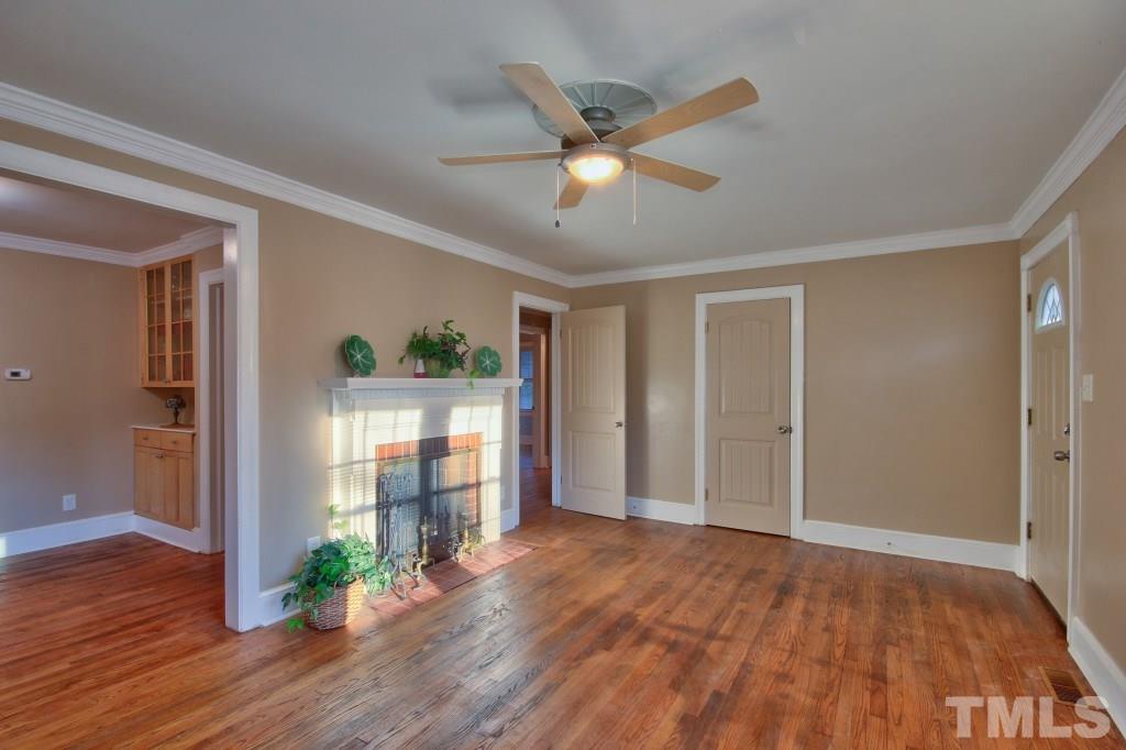 25 Bagwell Avenue Raleigh, NC 27607 - Photo 5 of 19 a view of an empty room with wooden floor and a window