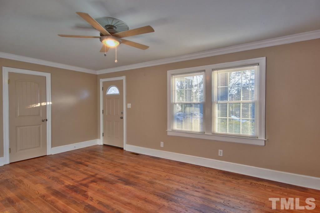 25 Bagwell Avenue Raleigh, NC 27607 - Photo 7 of 19 a view of an empty room with wooden floor and a window