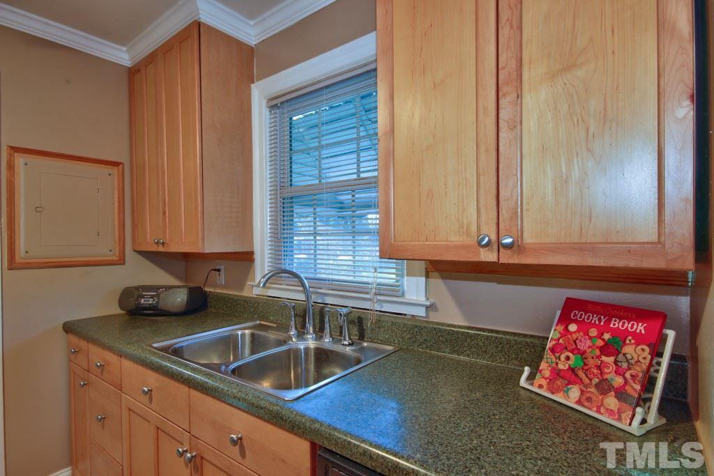 25 Bagwell Avenue Raleigh, NC 27607 - Photo 9 of 19 a kitchen with granite countertop a sink a stove and cabinets