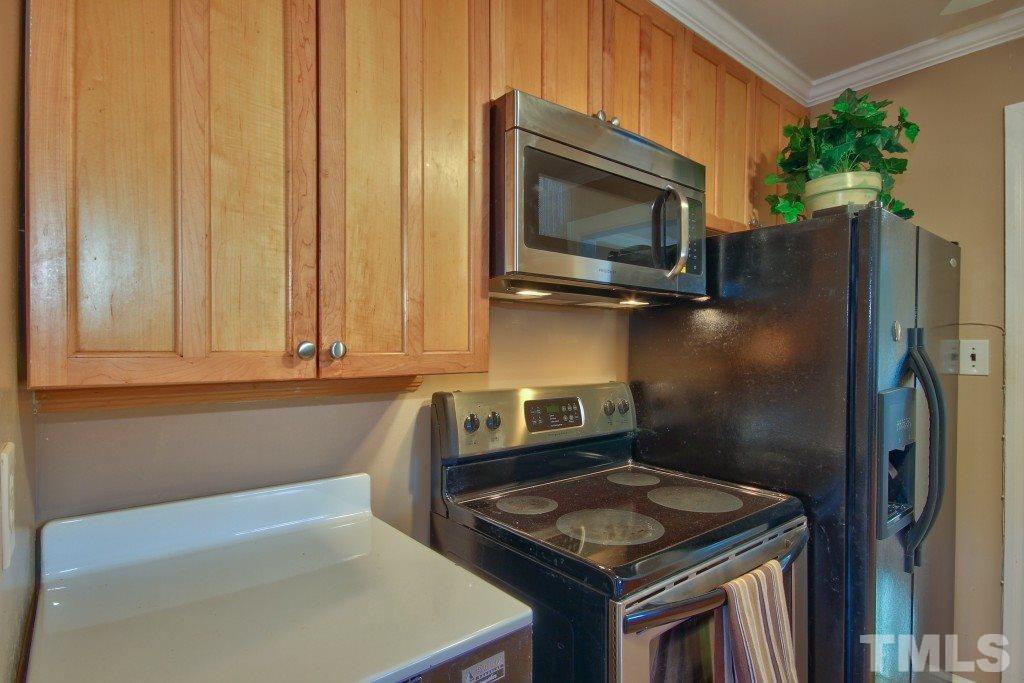 25 Bagwell Avenue Raleigh, NC 27607 - Photo 10 of 19 a kitchen with granite countertop a sink stove and microwave