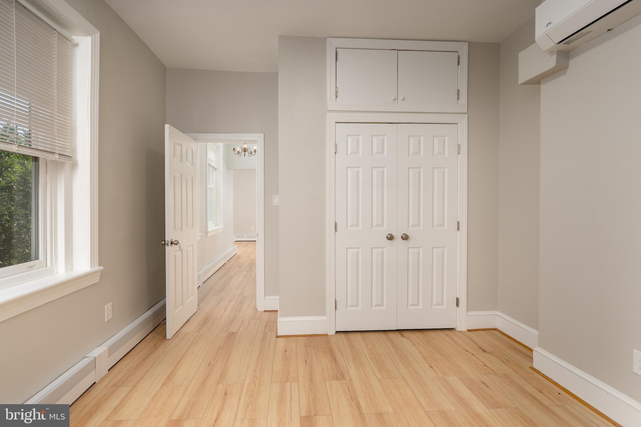 523 Constitution Avenue Northeast, Unit 3 Washington, DC 20002 - Photo 12 of 16 a view of an empty room with wooden floor and a window