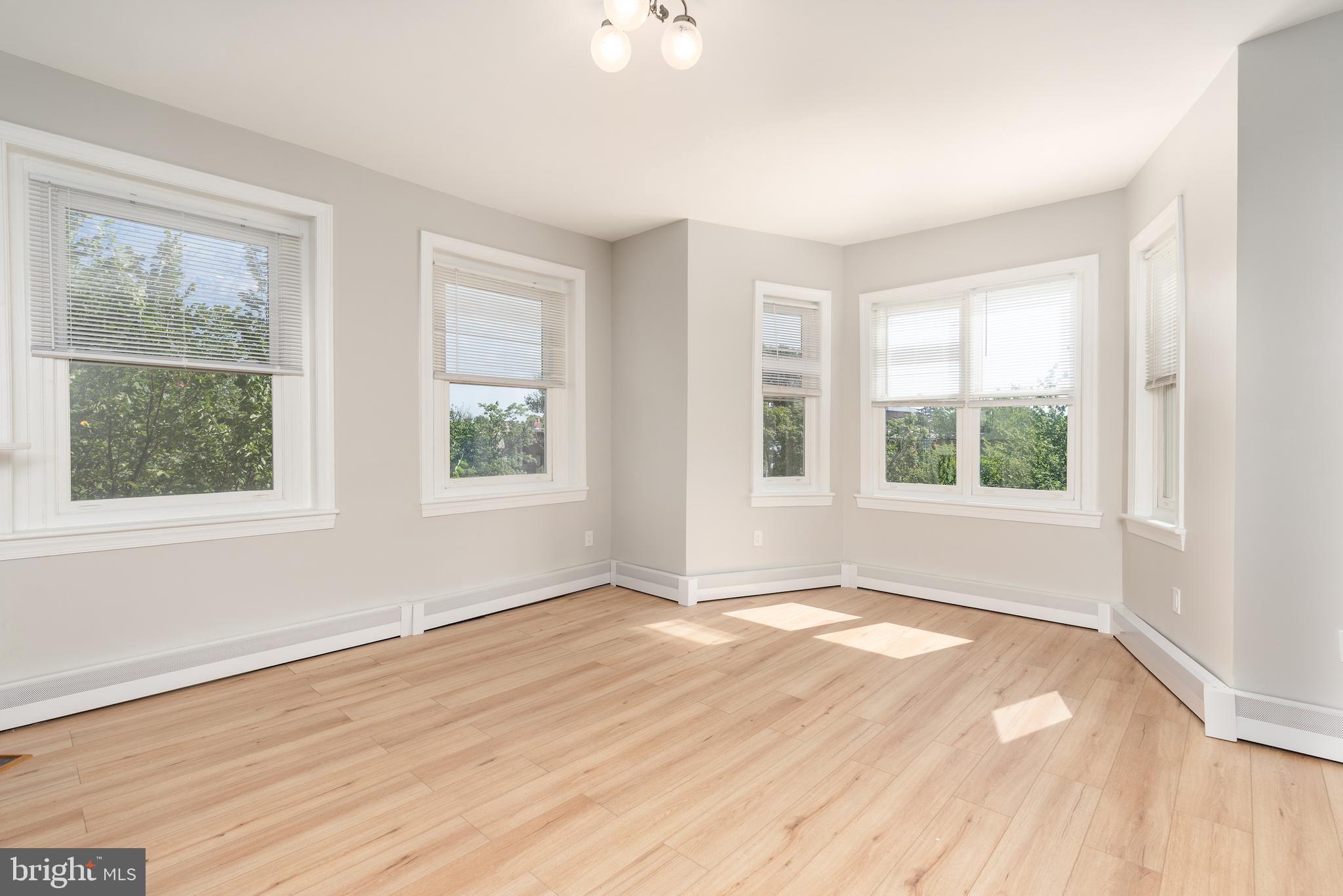 523 Constitution Avenue Northeast, Unit 3 Washington, DC 20002 - Photo 15 of 16 a view of an empty room with wooden floor and a window