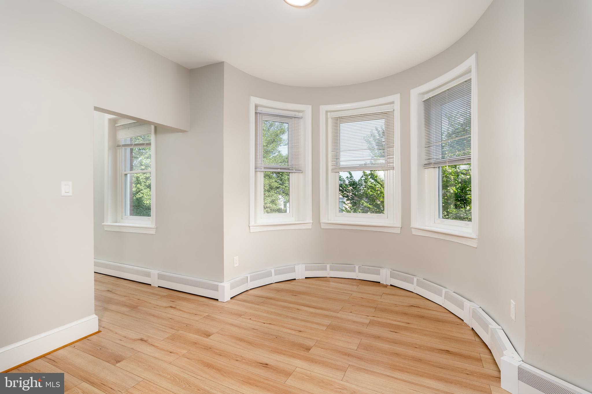 523 Constitution Avenue Northeast, Unit 3 Washington, DC 20002 - Photo 2 of 16 an empty room with wooden floor and windows