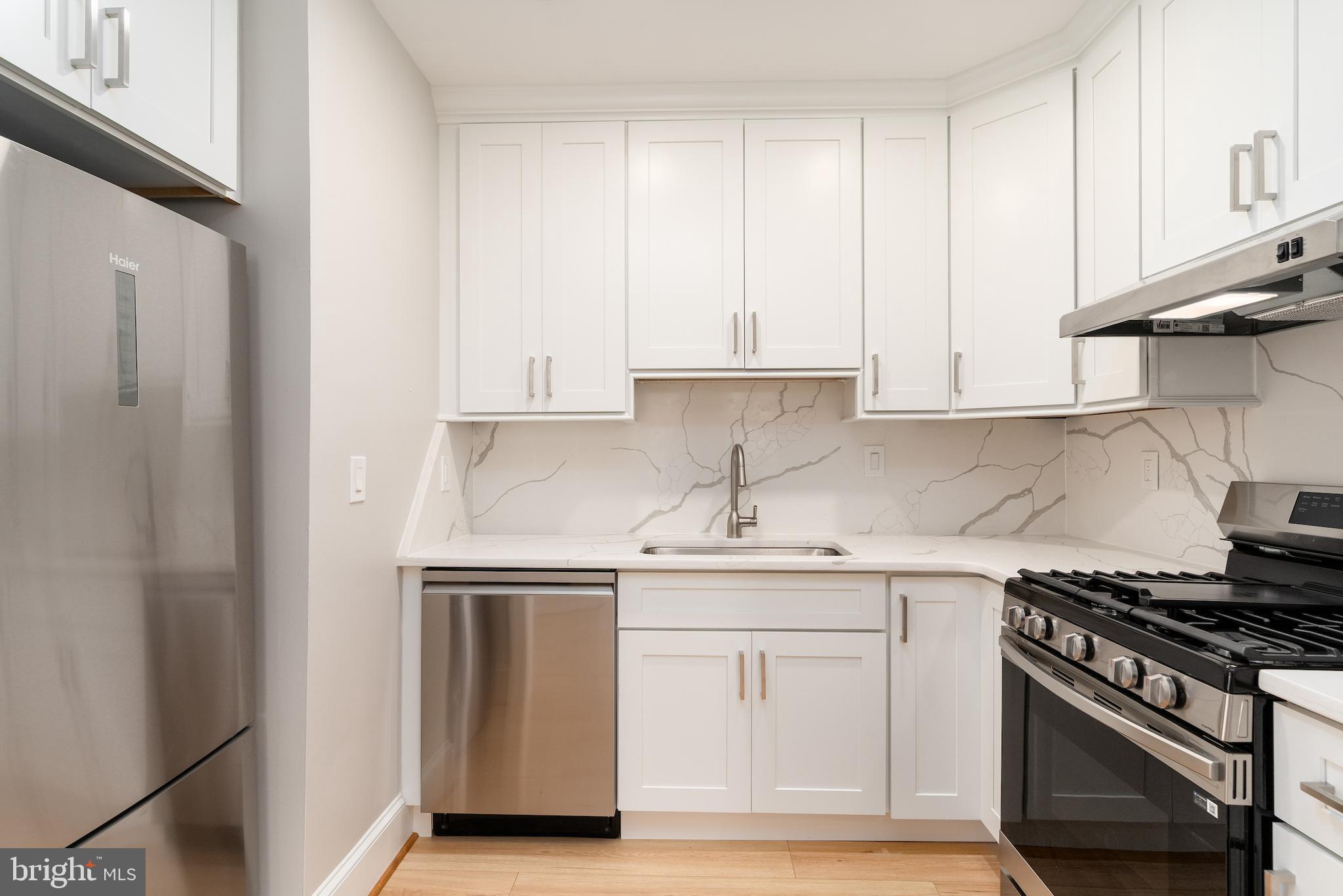 523 Constitution Avenue Northeast, Unit 3 Washington, DC 20002 - Photo 4 of 16 a kitchen with stainless steel appliances granite countertop a sink stove and cabinets