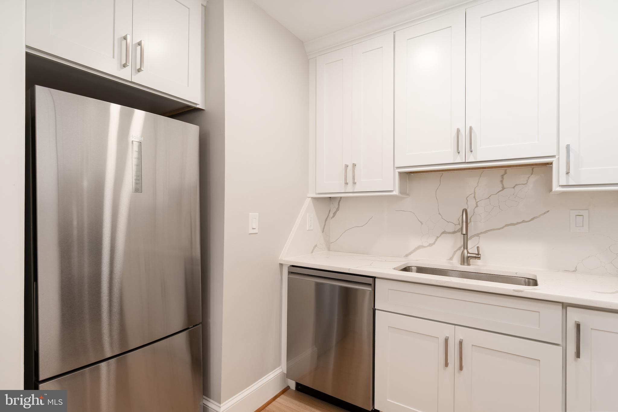 523 Constitution Avenue Northeast, Unit 3 Washington, DC 20002 - Photo 6 of 16 a kitchen with a sink and a refrigerator