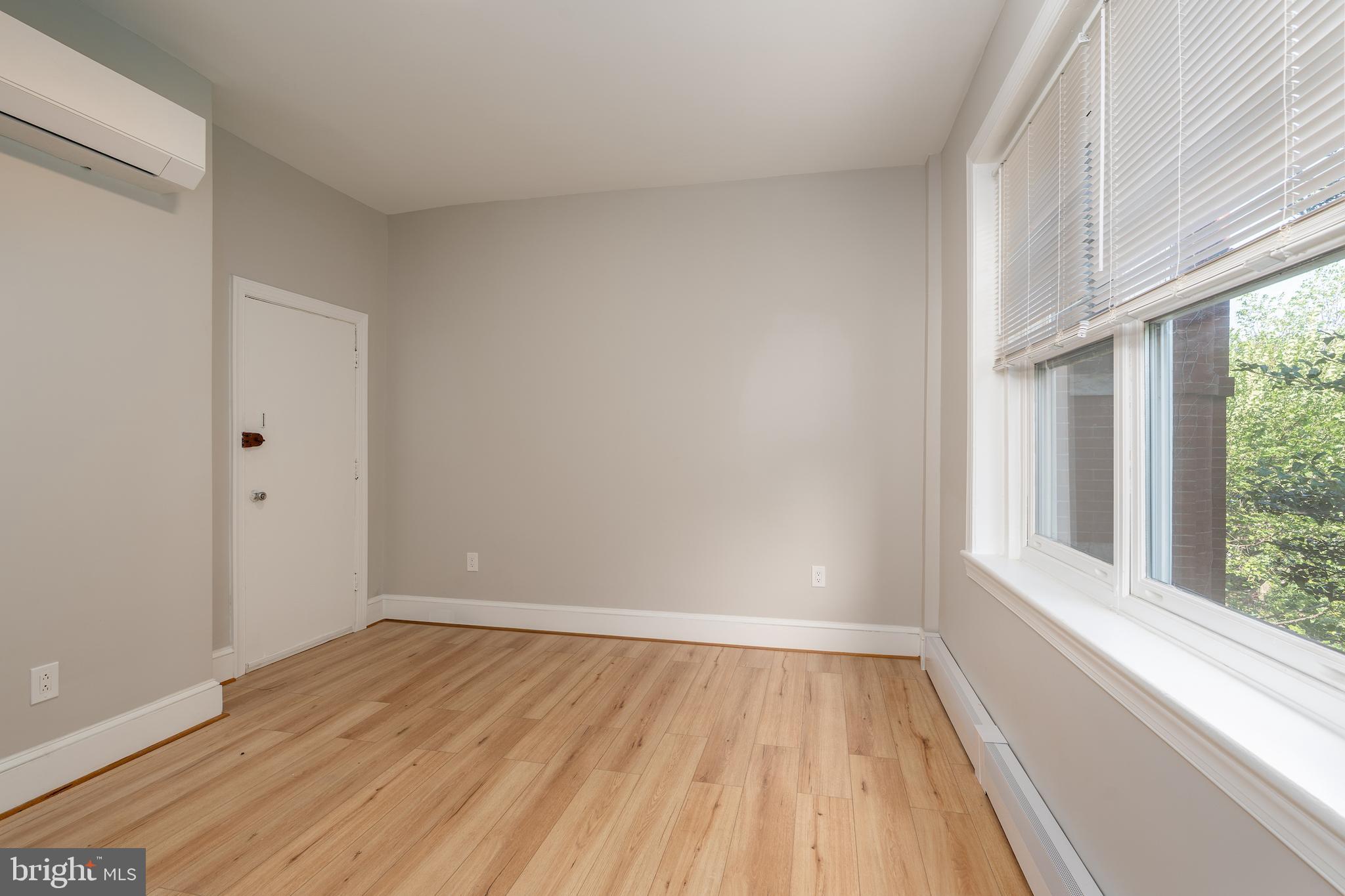 523 Constitution Avenue Northeast, Unit 3 Washington, DC 20002 - Photo 10 of 16 a view of an empty room with wooden floor and a window