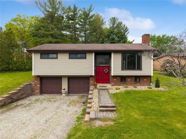 a front view of a house with a yard