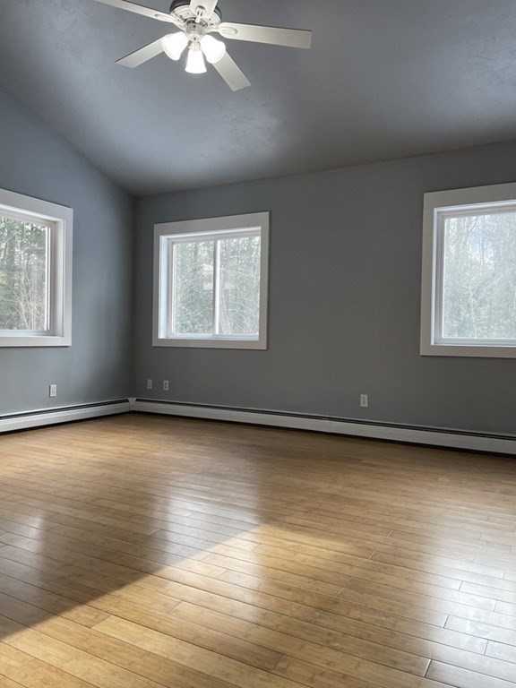 105 Sand Hill Road Shutesbury, MA 01072 - Photo 13 of 30 an empty room with wooden floor and windows