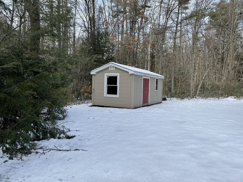 105 Sand Hill Road Shutesbury, MA 01072 - Photo 2 of 30 a front view of a house with a yard and garage