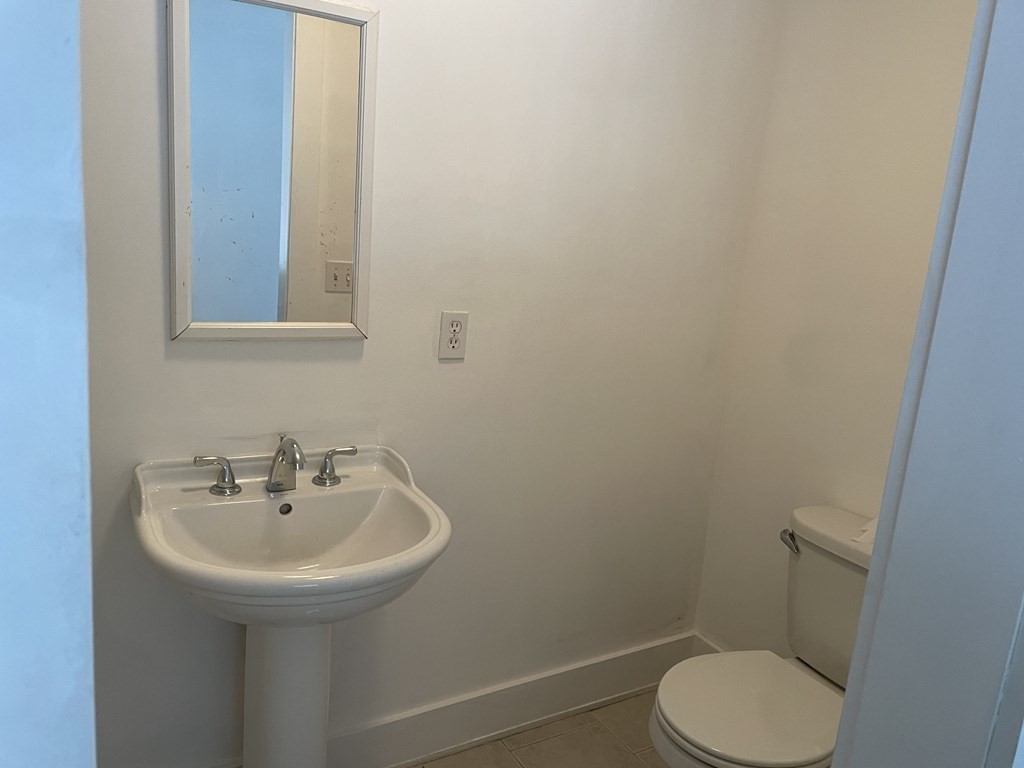 105 Sand Hill Road Shutesbury, MA 01072 - Photo 21 of 30 a bathroom with a sink mirror and toilet