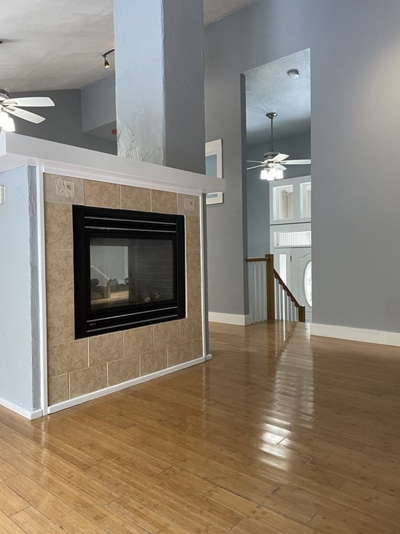 105 Sand Hill Road Shutesbury, MA 01072 - Photo 6 of 30 a view of an empty room with wooden floor and a fireplace