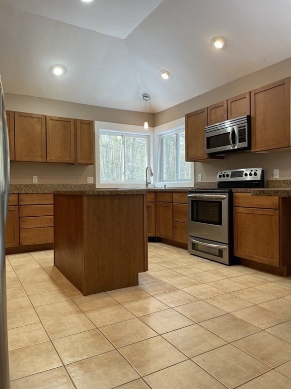 105 Sand Hill Road Shutesbury, MA 01072 - Photo 7 of 30 a kitchen with stainless steel appliances granite countertop a stove top oven a sink a counter top space and cabinets