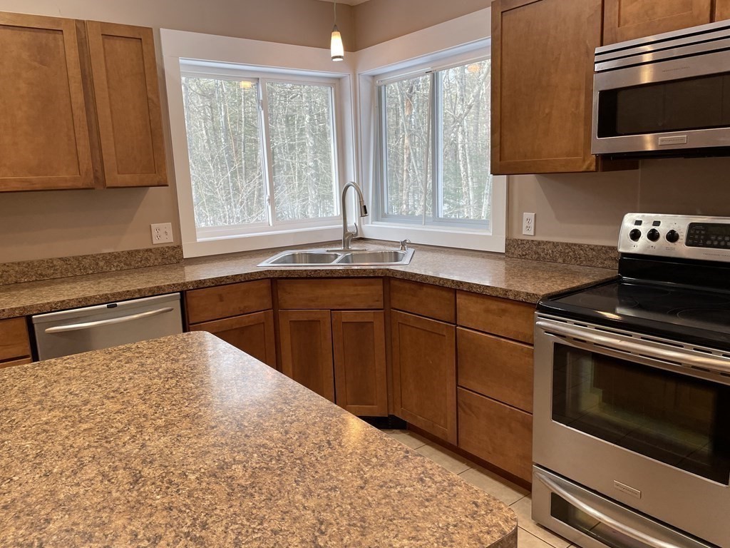 105 Sand Hill Road Shutesbury, MA 01072 - Photo 9 of 30 a kitchen with a sink stove and cabinets