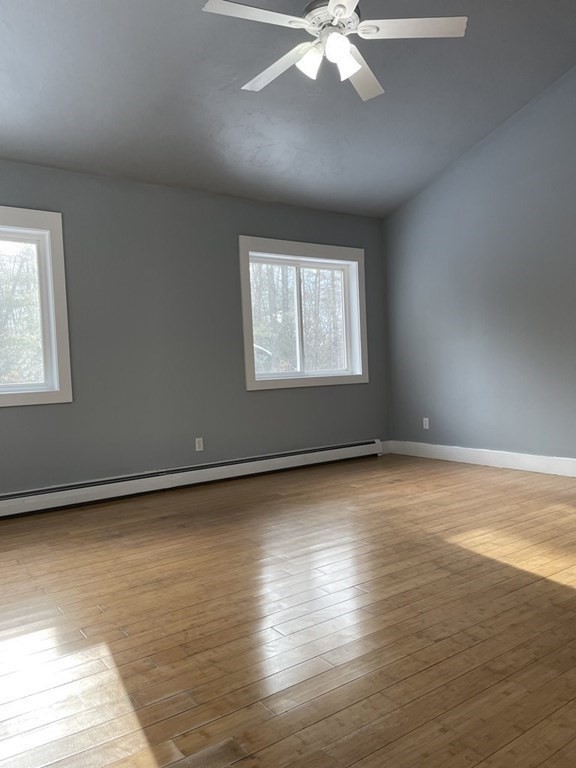105 Sand Hill Road Shutesbury, MA 01072 - Photo 10 of 30 an empty room with wooden floor and windows