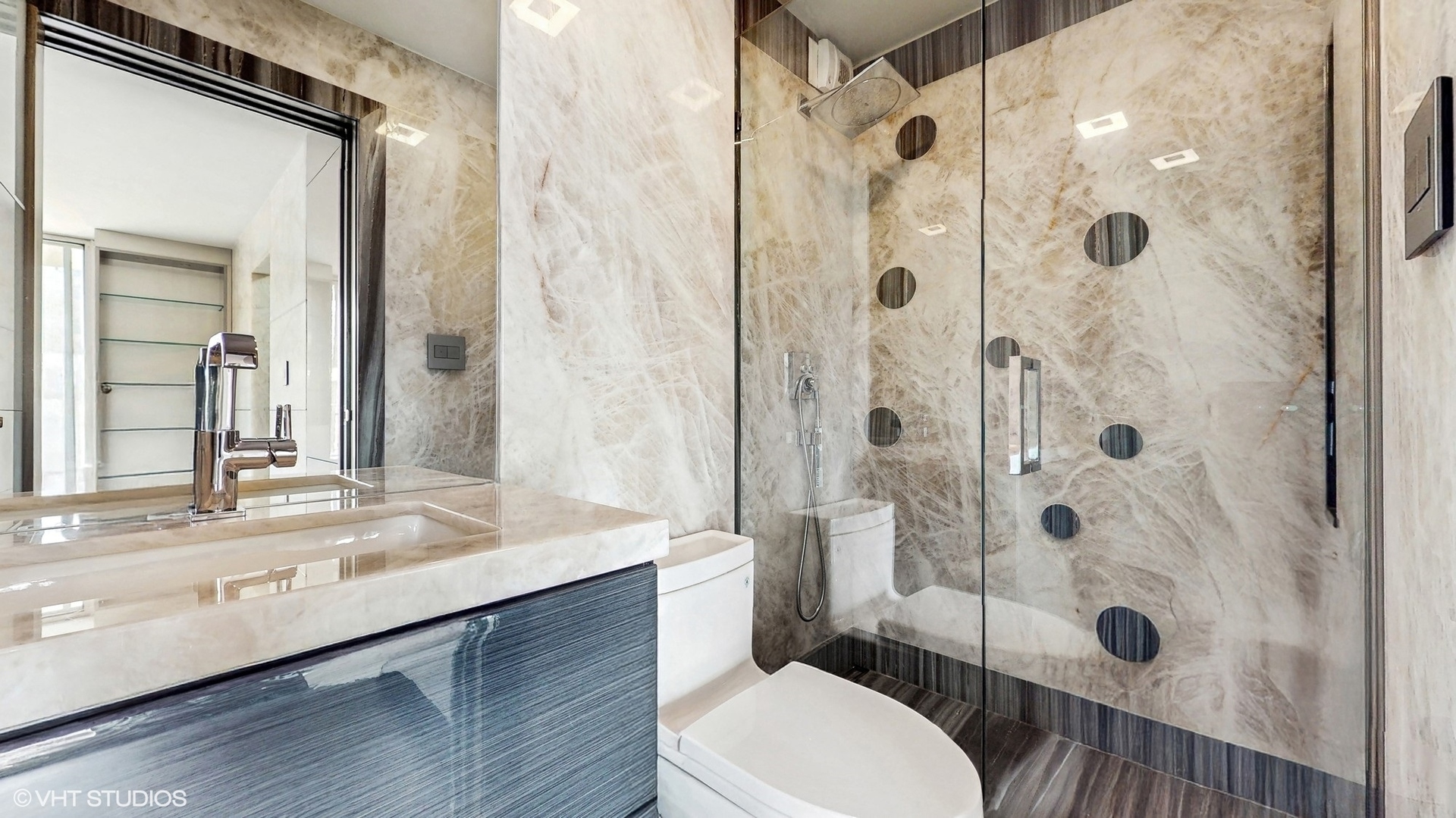 71 East Division Street, Unit 1801 Chicago, IL 60611 - Photo 20 of 31 a bathroom with a sink a toilet a glass door shower and a mirror