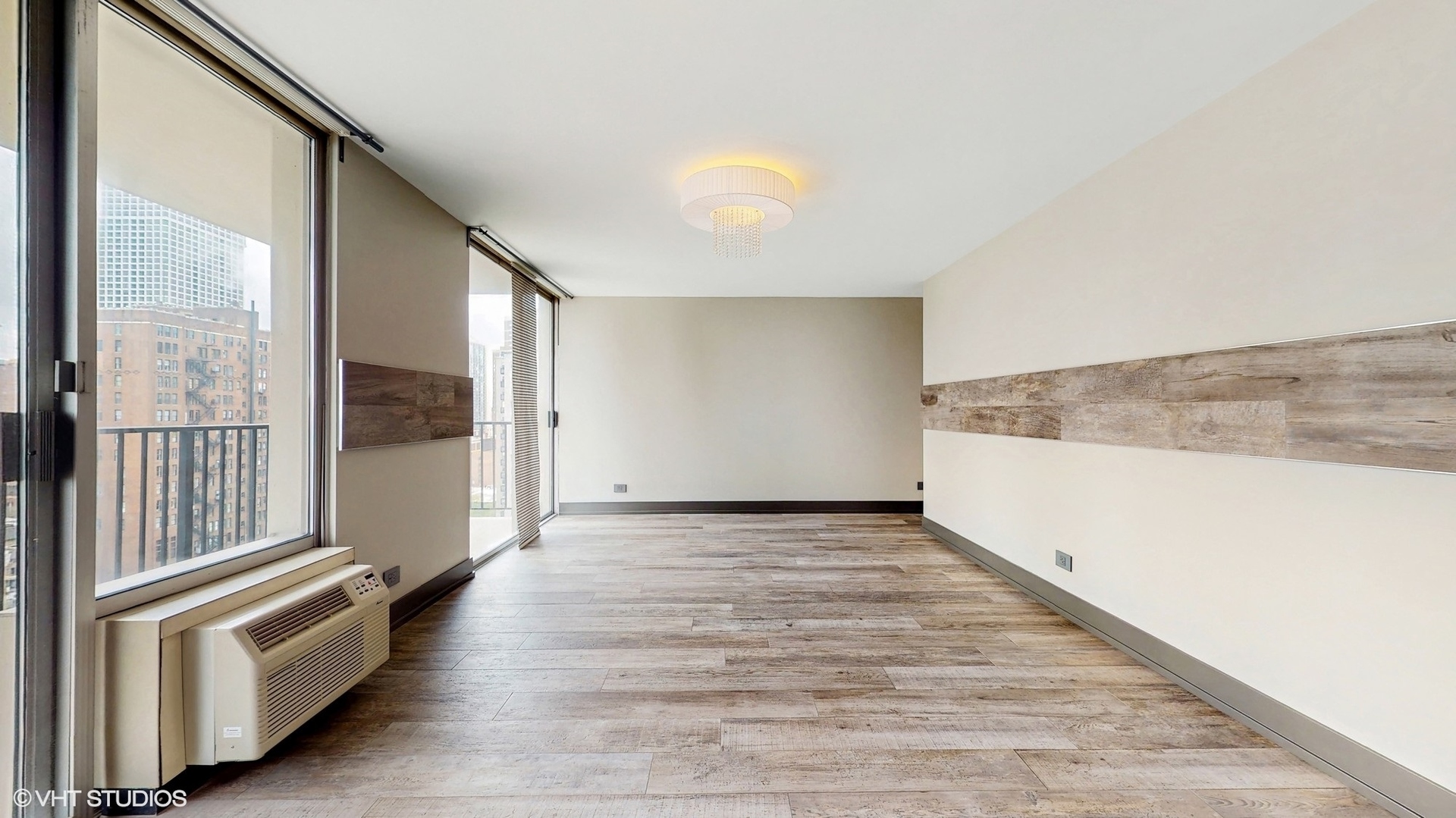 71 East Division Street, Unit 1801 Chicago, IL 60611 - Photo 10 of 31 wooden floor in an empty room with a window