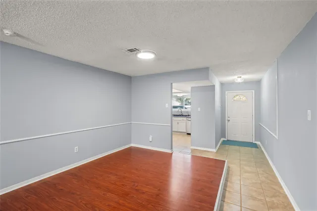 a view of a livingroom with wooden floor a fireplace and windows