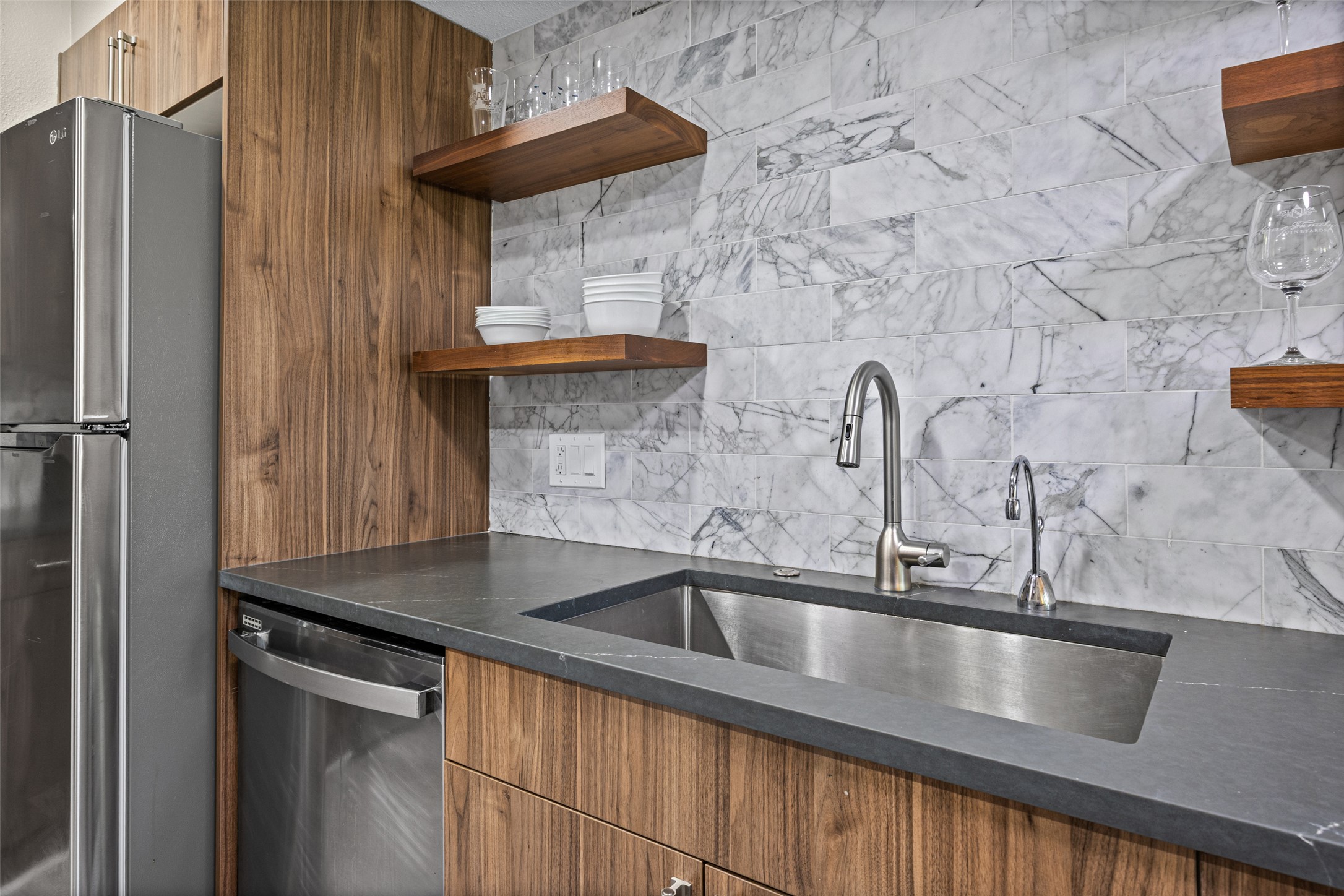 3809 Menchaca Road, Unit C Austin, TX 78704 - Photo 5 of 28 A well-appointed culinary space featuring sleek stainless steel appliances and contemporary wooden cabinetry.
