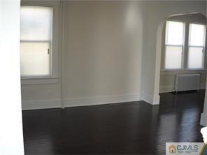 227 Washington Road Sayreville, NJ 08872 - Photo 7 of 16 an empty room with wooden floor and windows