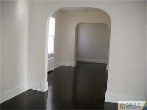 227 Washington Road Sayreville, NJ 08872 - Photo 8 of 16 an empty room with wooden floor door and windows