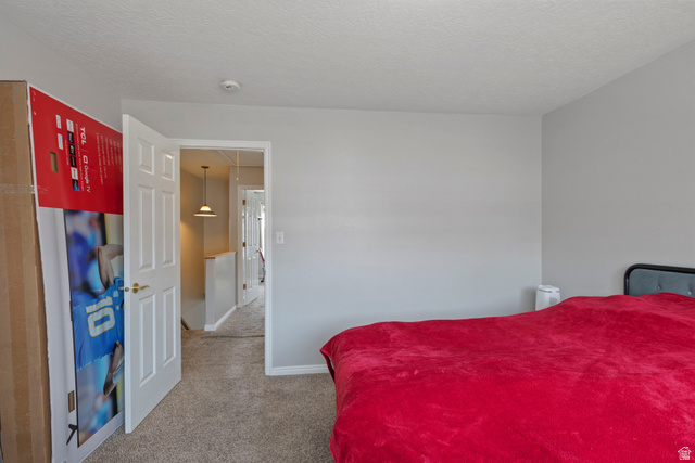 962 Independence Avenue Provo, UT 84604 - Photo 13 of 31 Bedroom featuring light colored carpet and a textured ceiling