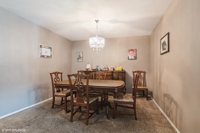 a view of a dining room with furniture and window