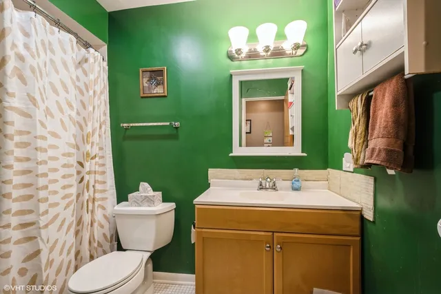 a bathroom with a sink mirror and toilet
